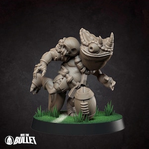 May include: A monochromatic, unpainted resin miniature of a horned, frog-like creature in a dynamic running pose, clutching a football. The figure wears armored gear and stands on a circular base with green grass tufts and a white line.