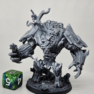 May include: A detailed, gray miniature of a fantasy creature, possibly a treant or golem, with a textured, bark-like appearance. The figure stands on a circular base, with a green and white die nearby, suggesting a tabletop game.