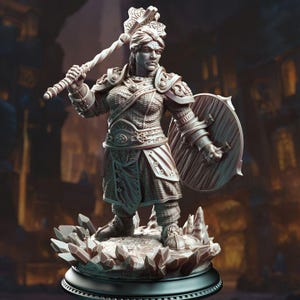 May include: A detailed miniature figurine of a female warrior wearing armor and holding a shield and a weapon. The figurine is painted in a light gray color and stands on a base with a crystal-like design.