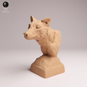 May include: A light brown, unpainted wolf bust figurine featuring detailed fur texture, pointed ears, and a focused expression, mounted on a solid, square-shaped base. The sculpture is rendered in a monochromatic, matte finish.