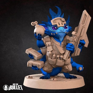 May include: A blue and brown miniature figurine of a creature with a large head, holding a bomb, a weapon, and a device. The creature has a blue body, brown arms, and a brown belt with pouches. The figurine is standing on a brown base.