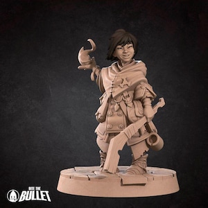 May include: A painted miniature figurine of a female character with brown hair, wearing a brown and white outfit, holding a staff and a small animal. The figurine is standing on a brown base.