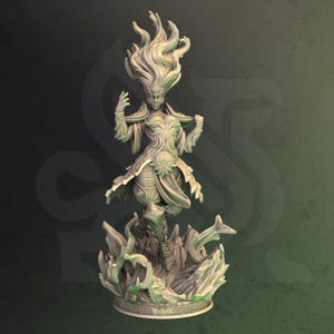 May include: A detailed, hand-painted miniature figurine of a female figure with flowing hair and a flowing gown, standing on a base with a swirling design.