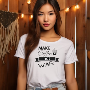 May include: White t-shirt with black text that reads "Make Coffee not War" and a stylized image of a coffee cup with steam coming from the top.