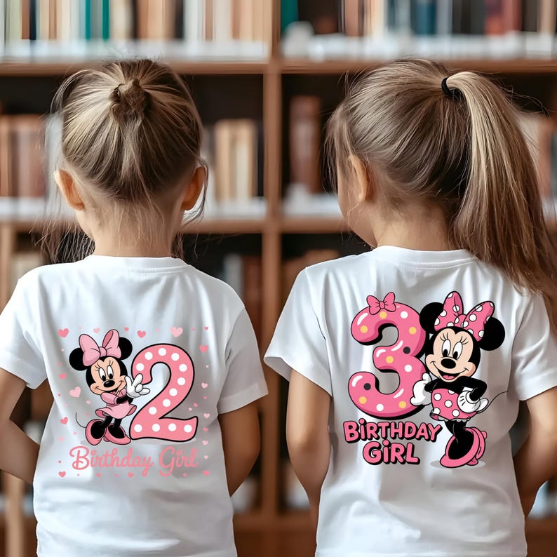 May include: Two white t-shirts with pink graphics. One shirt features a Minnie Mouse design with the number 2 and the text "Birthday Girl." The other shirt has a Minnie Mouse design with the number 3 and the text "Birthday Girl."