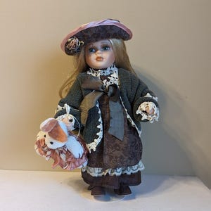 Vintage Porcelain Victorian Blonde Girl Doll Holding A Bunny Rabbit Toy