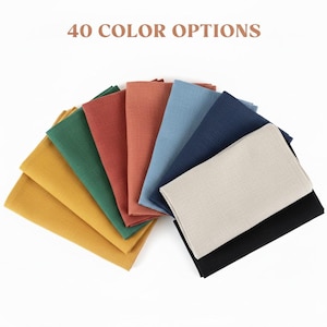 May include: A collection of folded fabric napkins in various colors, including yellow, green, red, blue, and black. The text "40 COLOR OPTIONS" is displayed at the top of the image.