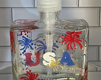 Patriotic USA soap dispenser for 4th of July with red, blue and gold fireworks and USA on the front.