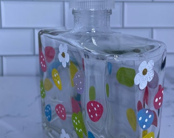 Easter egg soap dispenser. Colorful eggs and small white flowers