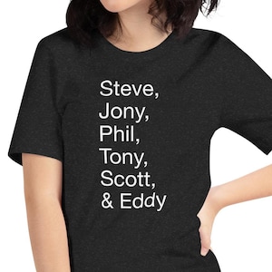 May include: A black t-shirt with white text that reads "Steve, Jony, Phil, Tony, Scott, & Eddy".
