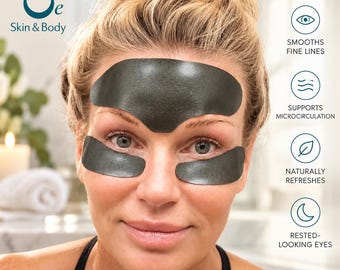 May include: A set of three dark gray skincare patches applied to the forehead and under-eye areas. The image includes the text Oe Skin & Body, along with icons and labels for smooths fine lines, supports microcirculation, naturally refreshes, and rested-looking eyes.