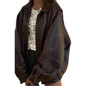 May include: A brown leather jacket with a zipper closure and a relaxed fit.