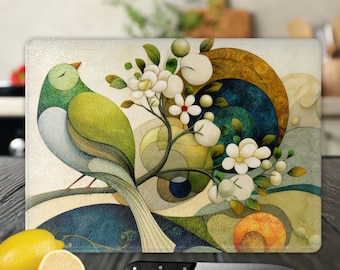 May include: A colorful abstract design featuring a green and blue bird perched on a branch with white flowers. The background is a mix of green, blue, and yellow geometric shapes.