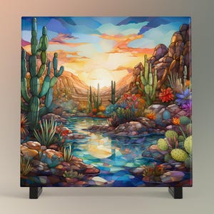May include: A stained glass style artwork depicting a desert landscape with a river flowing through it. The scene features cacti, mountains, and a sunset with a bright orange sky.