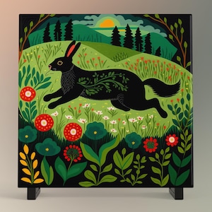 May include: A black rabbit with green vines growing on its back runs through a field of green grass and red and white flowers. The background shows a forest and a sunset.