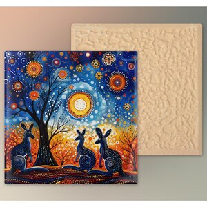 May include: A colorful ceramic tile with a blue, orange, and yellow background featuring three kangaroos standing in front of a tree. The background is filled with small circles and dots in various colors.