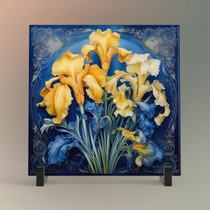 May include: A square ceramic tile featuring a floral design of yellow and white irises against a blue background. The irises are detailed with blue leaves and stems. The tile is displayed on a black stand.