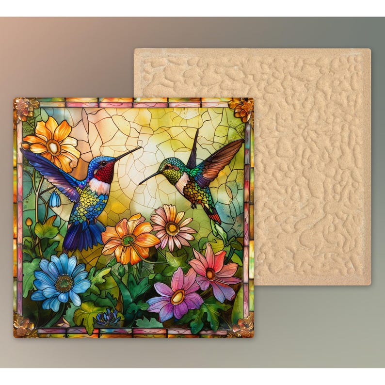 May include: A decorative square tile featuring a stained-glass design with two hummingbirds and colorful flowers. The tile has a detailed border and is accompanied by a plain, textured tile.