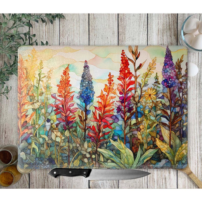 May include: A colorful watercolor painting of a field of flowers. The flowers are in shades of red, orange, yellow, blue, and purple. The background is a soft, hazy blue.