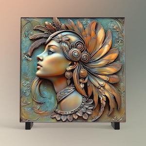 May include: A 3D wall sculpture of a woman's face with a gold and bronze finish. The woman is wearing a headdress of feathers and intricate jewelry. The background is a textured blue and green.