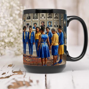 May include: Black ceramic mug featuring a vibrant image of a group of women in blue and yellow attire, standing in front of a wall of portraits. The mug has a black handle and rim, with a detailed interior scene.