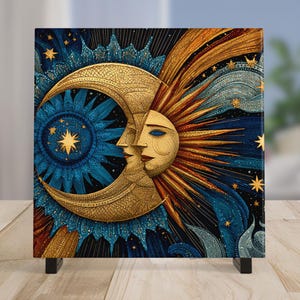 May include: A square canvas print featuring a celestial design. The artwork depicts a golden crescent moon and sun with faces, set against a dark blue background with stars. The print is supported by two small black legs.