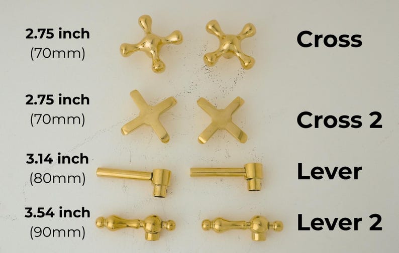 May include: Gold-toned metal cabinet knobs in four different styles: cross, cross 2, lever, and lever 2. The knobs are shown in various sizes, ranging from 2.75 inches (70 mm) to 3.54 inches (90 mm).