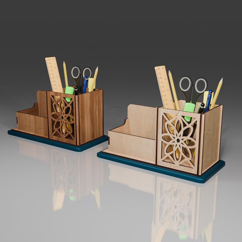 May include: Two wooden desk organizers with a teal base. Each organizer has a compartment for pens and pencils, a small drawer, and a decorative cutout design. The organizers are filled with various office supplies, including rulers, scissors, and pens.