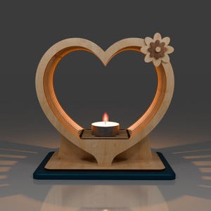 May include: A wooden heart-shaped candle holder with a small flower design on the top. The holder has a small platform in the centre for a tea light candle.