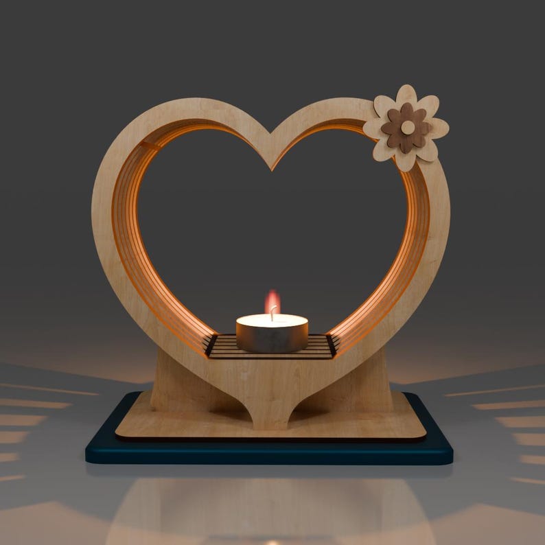 May include: A wooden heart-shaped candle holder with a small flower design on the top. The holder has a small platform in the centre for a tea light candle.