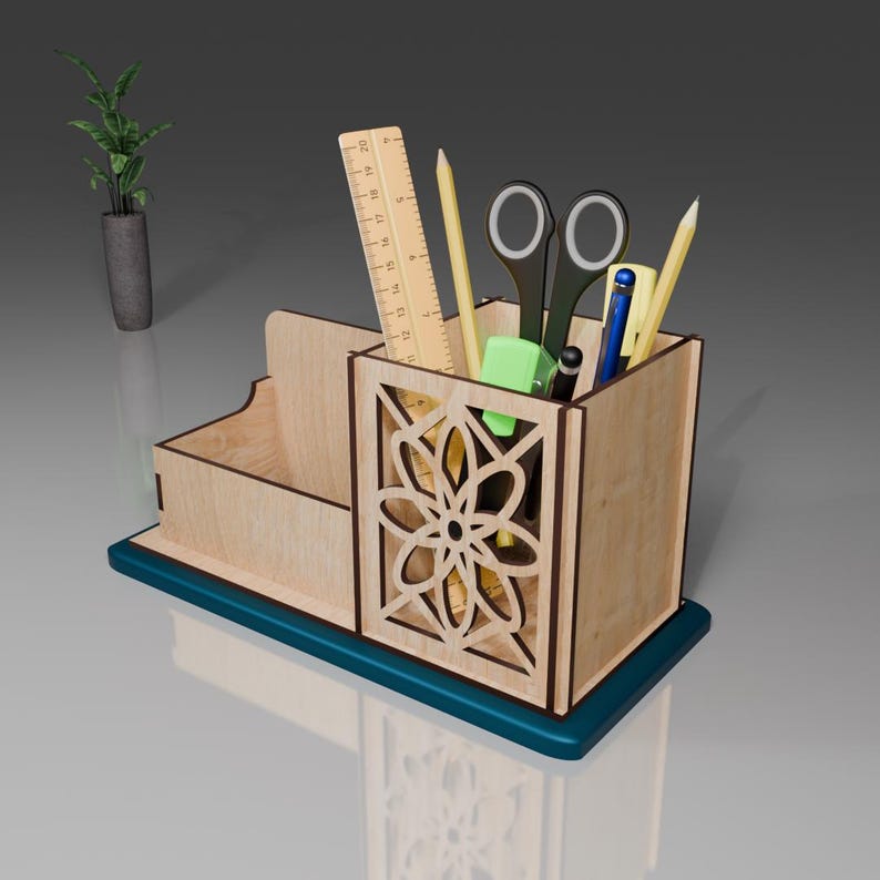 May include: Wooden desk organizer with a teal base and a cutout design. It has compartments for pens, pencils, and other office supplies.