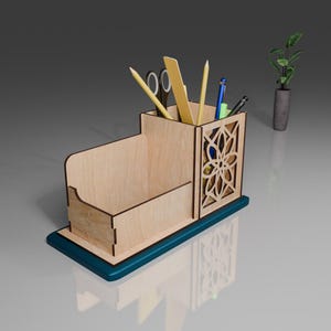 May include: A wooden desk organizer with a blue base. It has a compartment for pens and pencils, a slot for a ruler, and a small open compartment. The organizer is filled with various writing utensils.