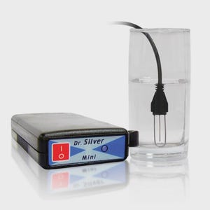 May include: A black and blue Dr. Silver Mini device with a red on/off switch, next to a glass of water with a submerged black and silver component. The device has the text "Dr. Silver Mini" on it.