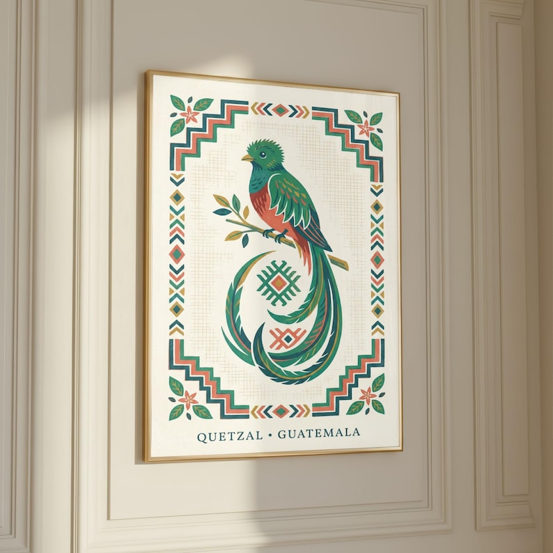 a framed illustration of a colorful bird, likely a quetzal, perched on a branch. The bird is surrounded by a decorative border with geometric patterns and designs. The text "QUetzal - Guatemala" is visible, indicating the bird is a quetzal from Guatemala.