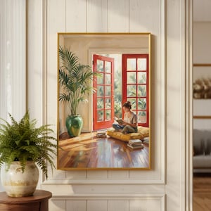 May include: A framed painting shows a person reading in a sunlit room with red French doors opening to a garden. A large green potted plant and books are visible. The painting has a gold frame and is displayed on a white wall.
