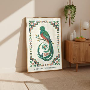 a large framed poster of a colorful bird, likely a quetzal, in a room with a wooden cabinet and a potted plant.