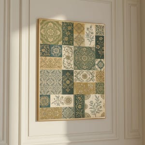 May include: A framed artwork featuring a patchwork design of floral and geometric patterns in shades of green, beige, and gold. The artwork is displayed on a white wall, showcasing a vintage aesthetic.