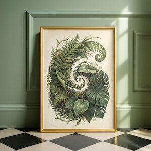 Può includere: Una stampa botanica incorniciata con un'illustrazione dettagliata di varie felci verdi e foglie tropicali. L'opera d'arte è ambientata su uno sfondo color crema e incorniciata in una cornice dorata. La stampa è esposta contro un muro verde.