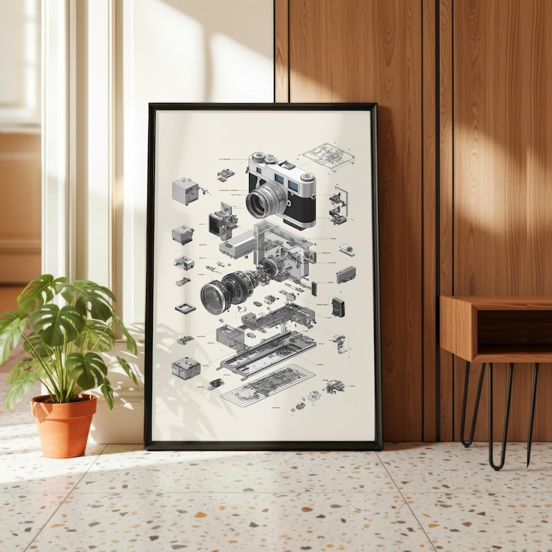a large, framed poster of a disassembled camera, with various parts and components visible. The poster is displayed on a wall, and there is a potted plant and a wooden table nearby.