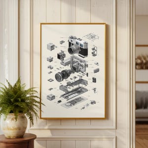 May include: An exploded view illustration of a vintage camera, showcasing its internal components. The artwork is framed in gold and hangs on a cream-colored wall. The camera's parts are meticulously detailed, offering a glimpse into its mechanics.