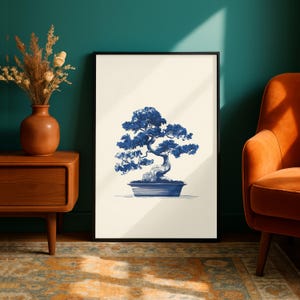 May include: A framed print featuring a blue and white bonsai tree illustration. The artwork depicts a detailed bonsai tree in a rectangular pot, set against a cream-colored background. The print is displayed in a black frame, suitable for home decor.
