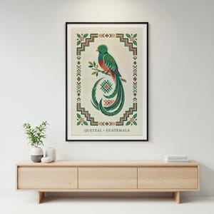 a framed poster of a colorful bird, likely a quetzal, hanging on a wall above a wooden entertainment center.