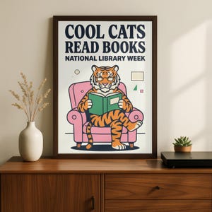 A framed poster with a cartoon tiger sitting in a pink chair and reading a book, celebrating National Library Week.