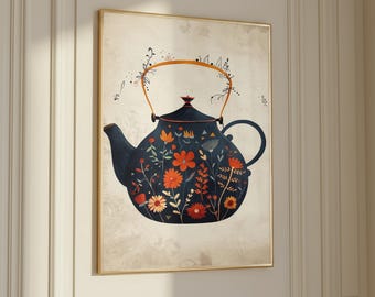 May include: A framed print featuring a navy blue teapot adorned with orange, yellow, and white floral designs. The teapot has a gold handle and spout, set against a beige background. The artwork is displayed on a white wall.