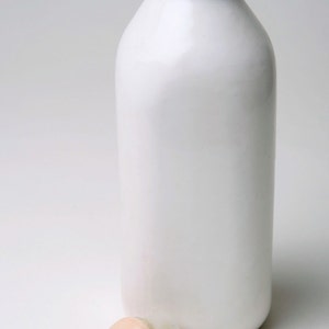 Baby Hand Emerging from Milk Bottle Stopper with a Cause image 4