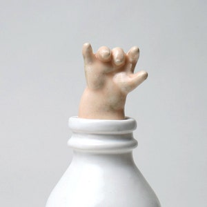 Baby Hand Emerging from Milk Bottle Stopper with a Cause image 1