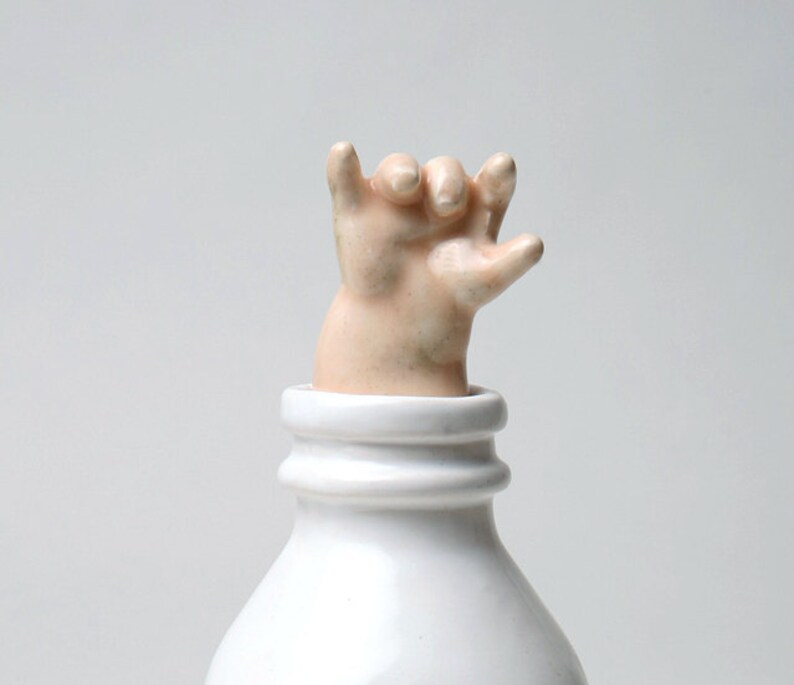 Baby Hand Emerging from Milk Bottle Stopper with a Cause image 1