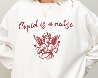Cupid is a nurse Sweater,Nurse Valentine Gift Sweatshirt,Nurse Valentines Day Sweatshirts,Valentine Nurse Sweaters,Valentine Nursing Sweater