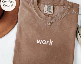 May include: A brown t-shirt with the word "werk" printed on the front. The shirt is made by Comfort Colors and is in the color Espresso.