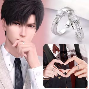 May include: Two silver rings with a star-shaped design featuring clear cubic zirconia stones. The rings are intertwined and are a popular choice for couples.